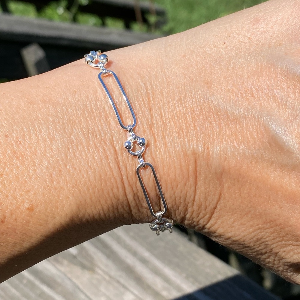 Silver plated link chain bracelet 6 mm wide; 7.5 inches long. 
Brand new.